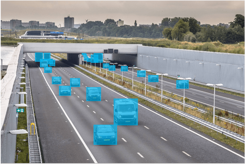 vehicles on a highway annotated using bounding boxes