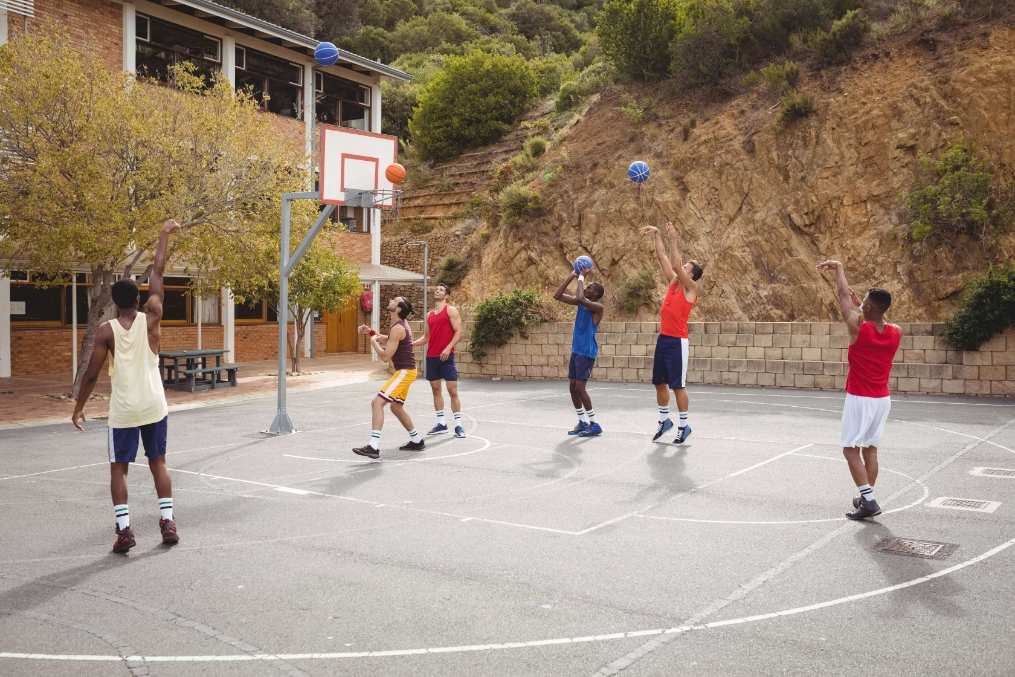 people playing basketball on a court